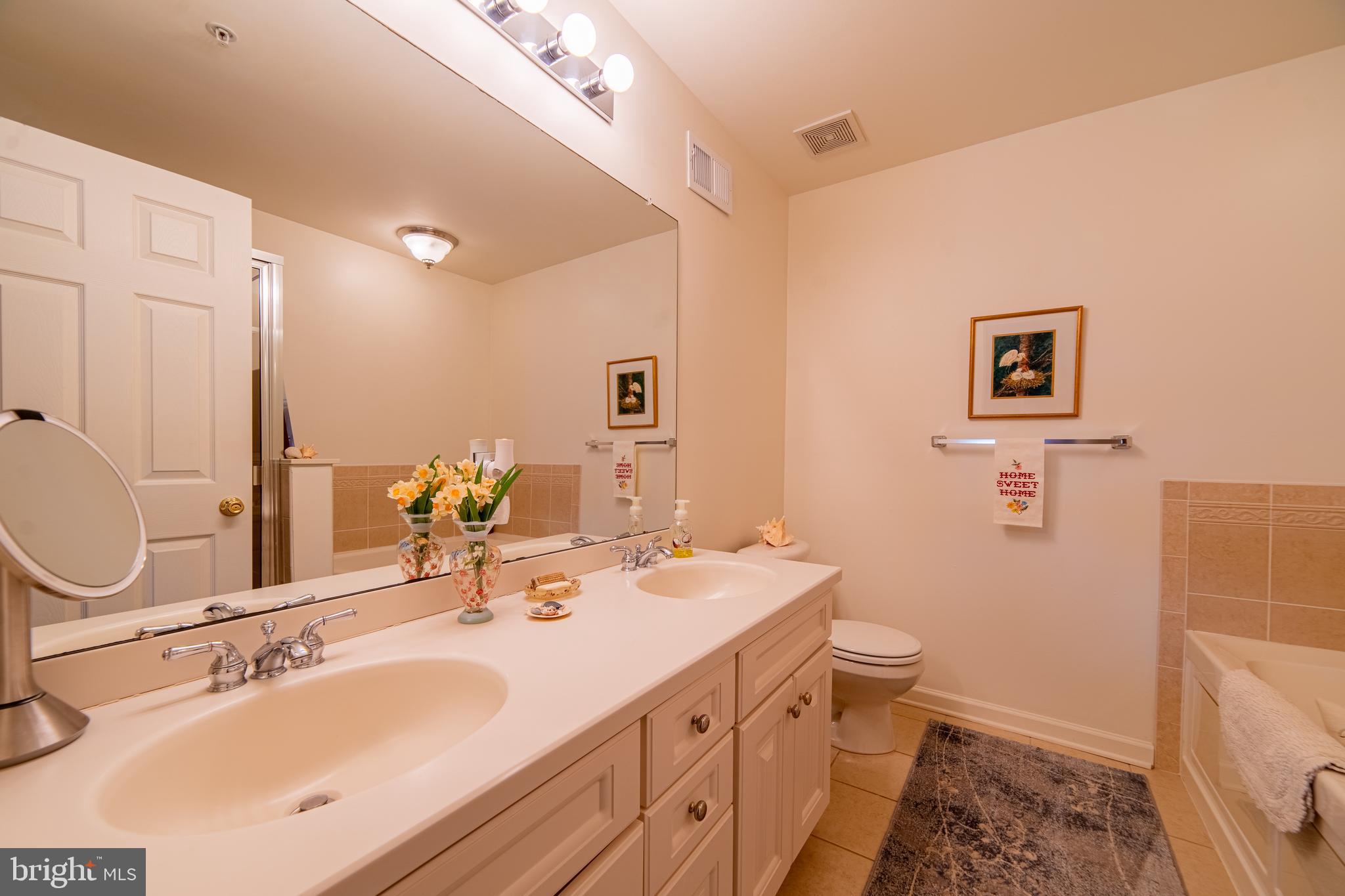 61 Dockside Drive Somers Point, NJ 08244 - Photo 13 of 23 a bathroom with a double vanity sink mirror and toilet
