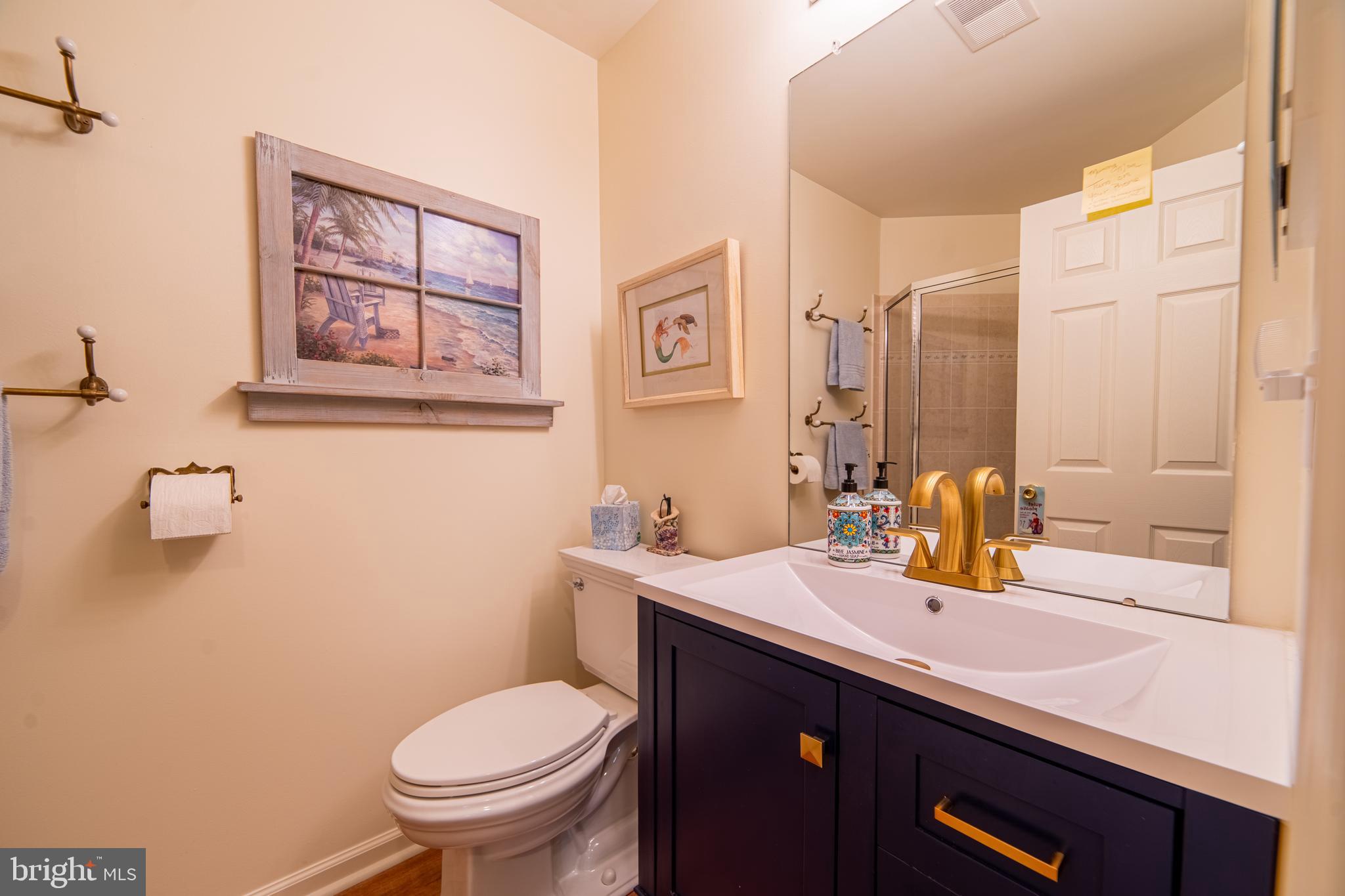 61 Dockside Drive Somers Point, NJ 08244 - Photo 6 of 23 a bathroom with a sink a toilet and mirror