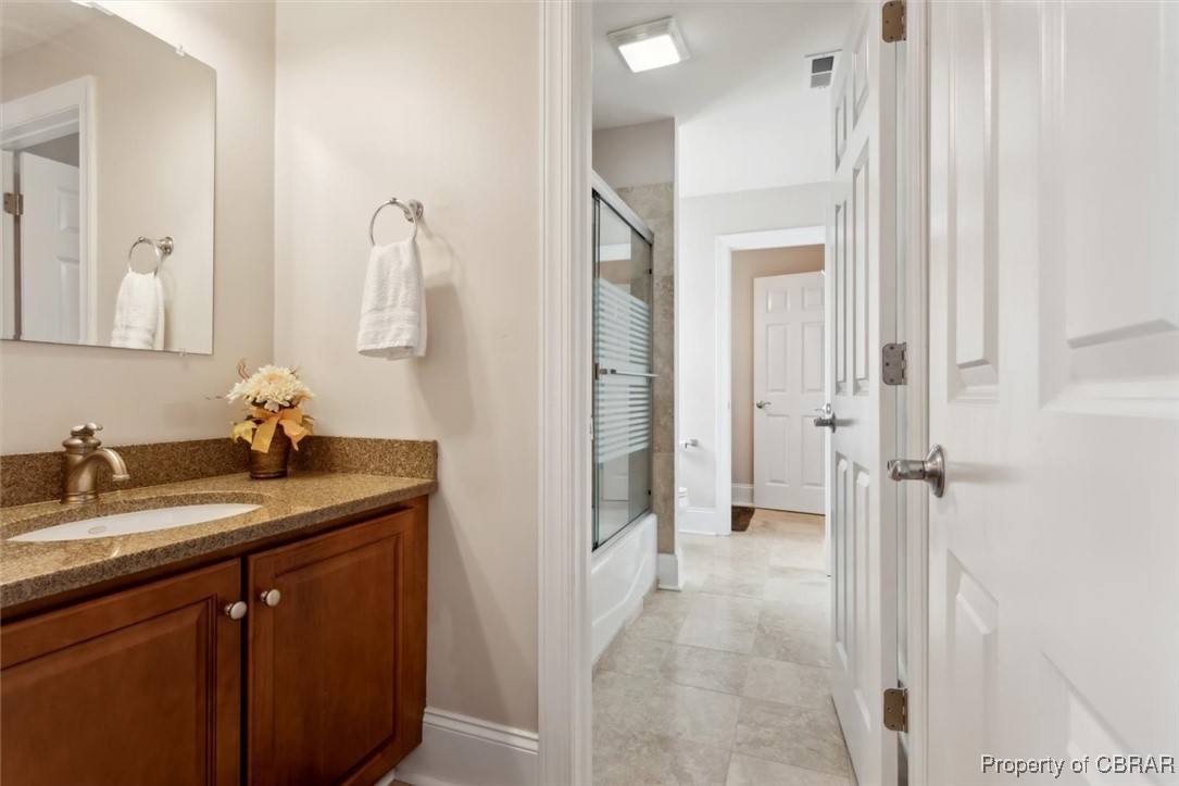 3013 Ridge Drive Toano, VA 23168 - Photo 29 of 50 Bathroom featuring visible vents, baseboards, vanity, and bath / shower combo with glass door