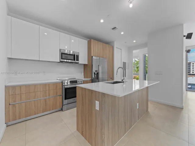 a large kitchen with stainless steel appliances kitchen island granite countertop a large counter top stainless steel appliances and cabinets