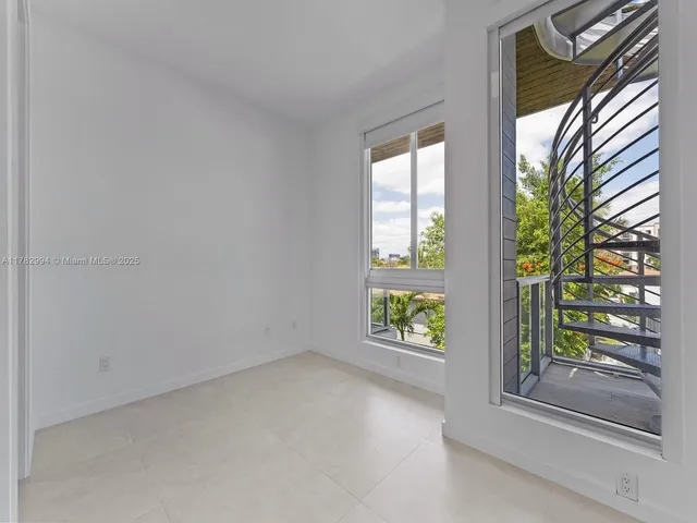 a view of a living room and a balcony