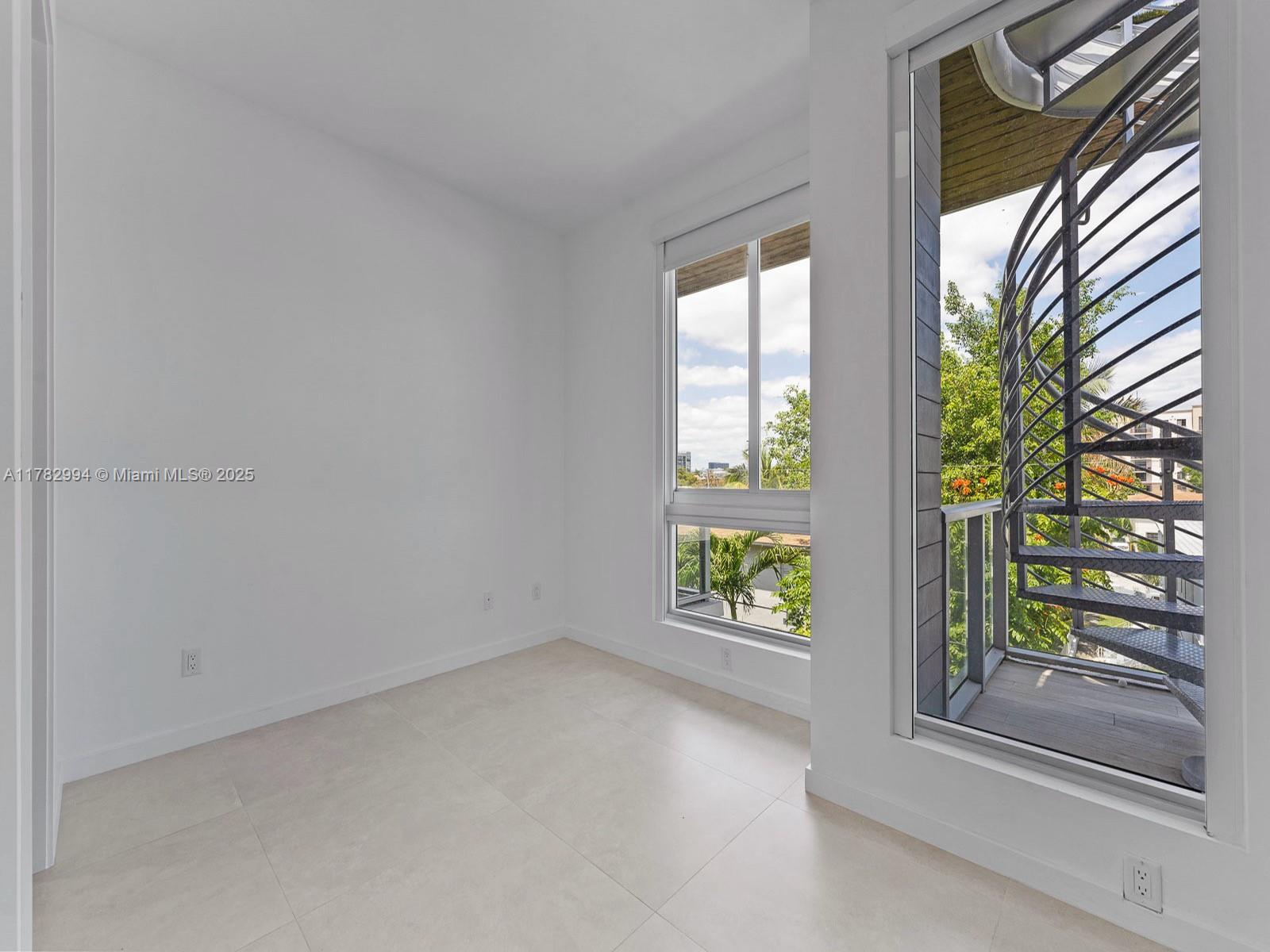 529 Southwest 11th Street, Unit 303 Miami, FL 33129 - Photo 16 of 64 an empty room with windows and window