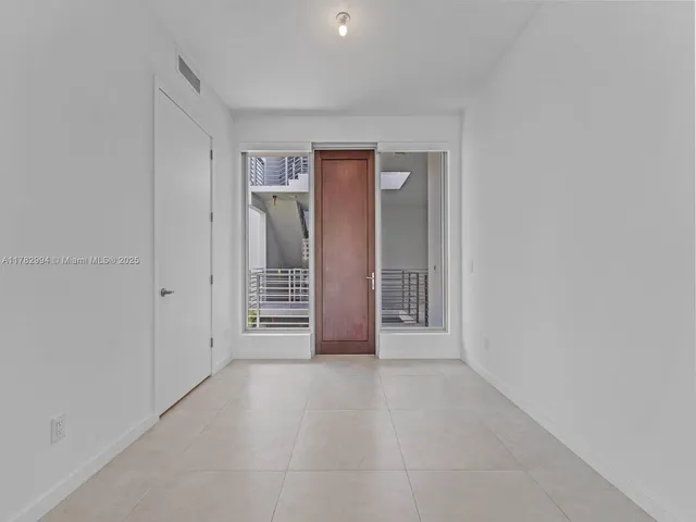 a view of an empty room with closet