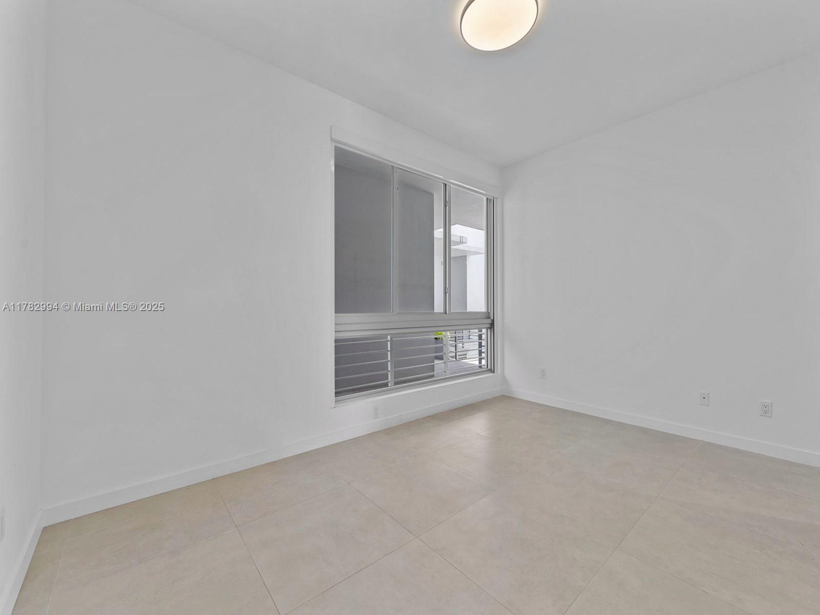 529 Southwest 11th Street, Unit 303 Miami, FL 33129 - Photo 32 of 64 a view of empty room with window