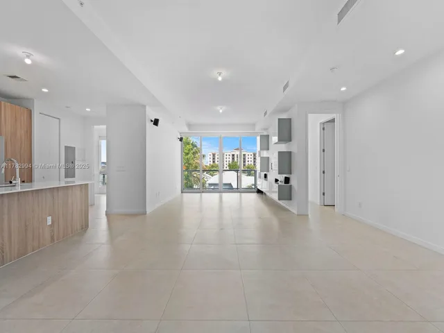 a view of a kitchen with refrigerator and a sink