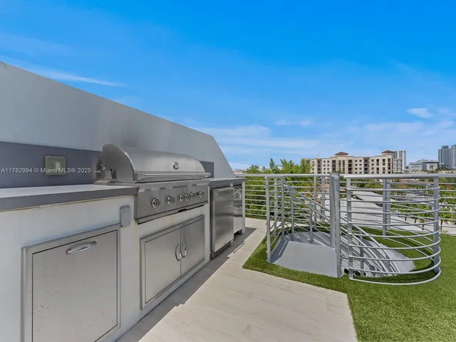 a view of a patio with a table and chairs under an umbrella