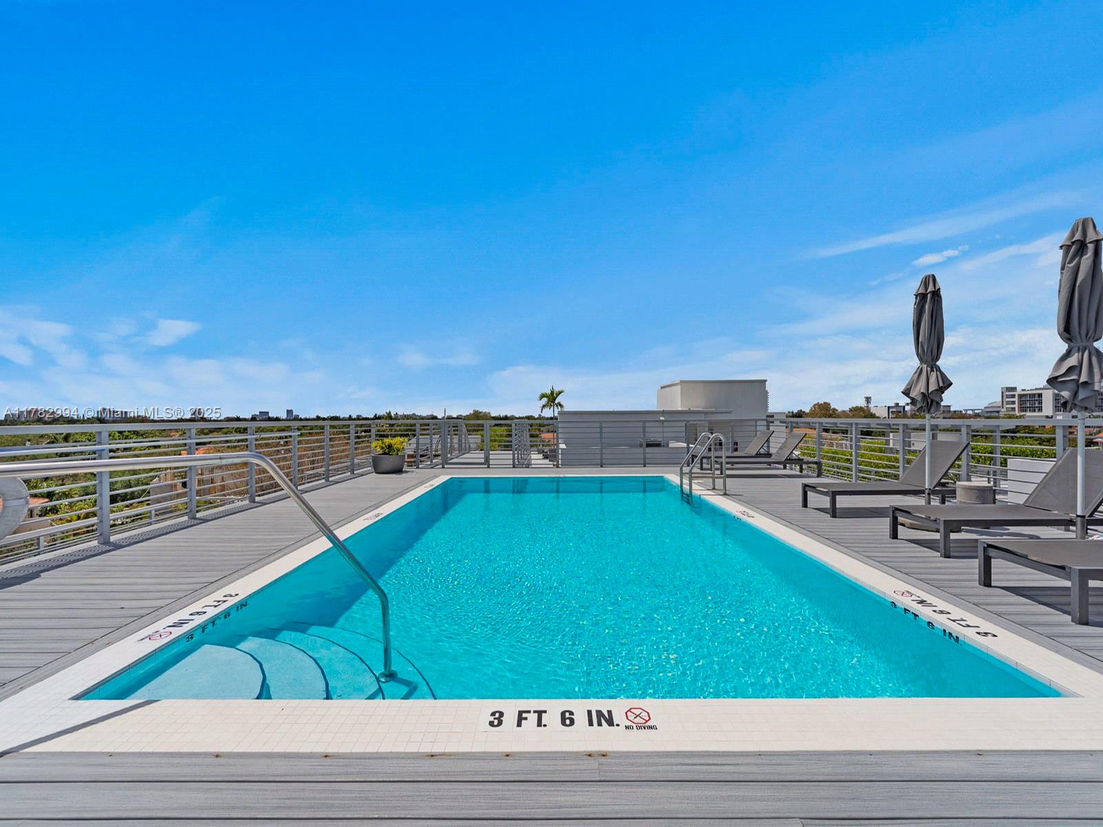 529 Southwest 11th Street, Unit 303 Miami, FL 33129 - Photo 50 of 64 a view of a swimming pool and lounge chair