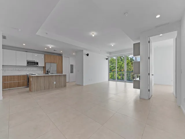 a view of a kitchen with a sink and cabinets
