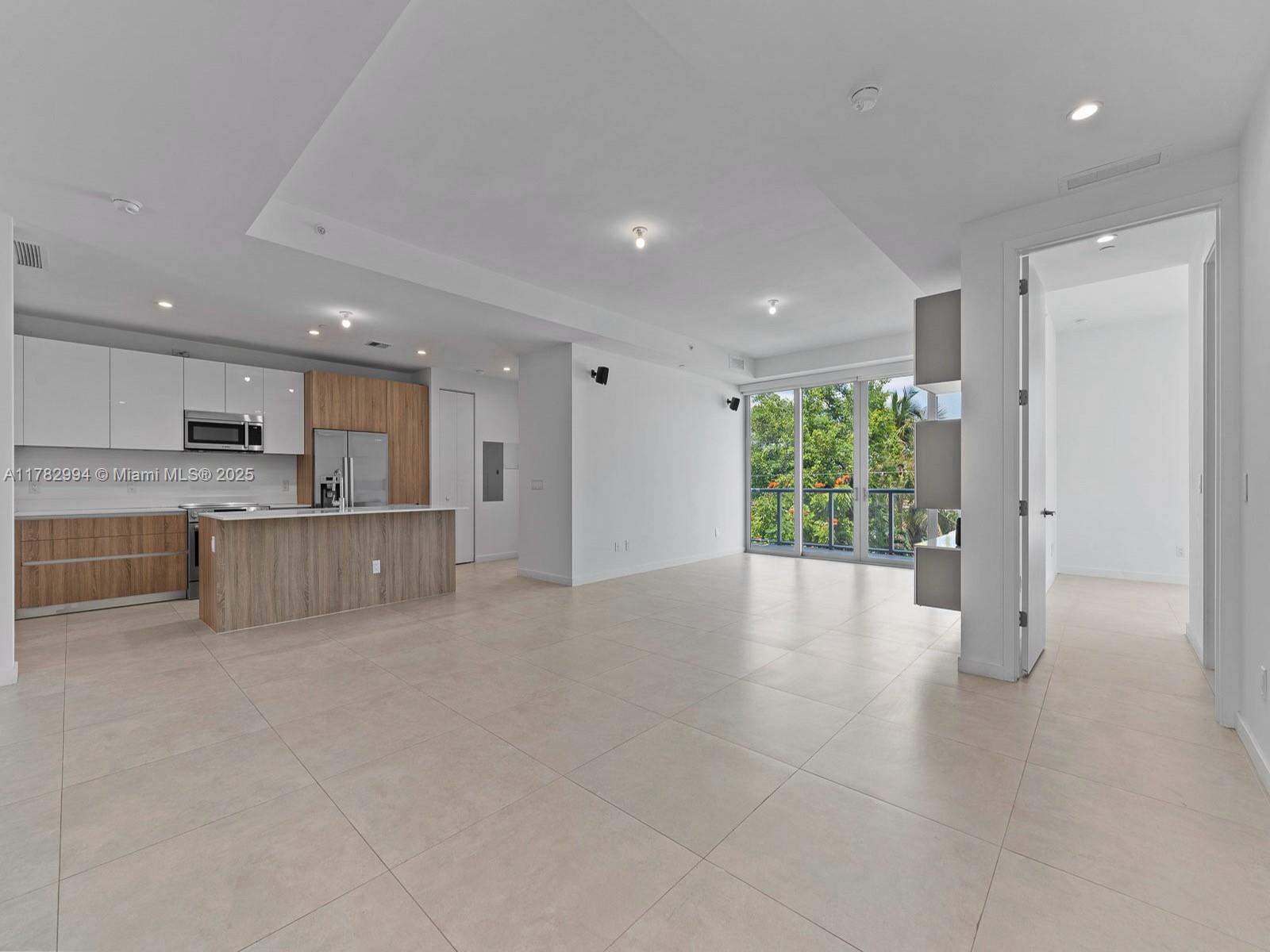 529 Southwest 11th Street, Unit 303 Miami, FL 33129 - Photo 6 of 64 a view of an empty room with a kitchen