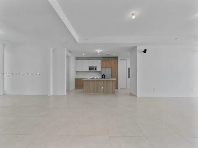 a view of a living room hardwood floor and a large window
