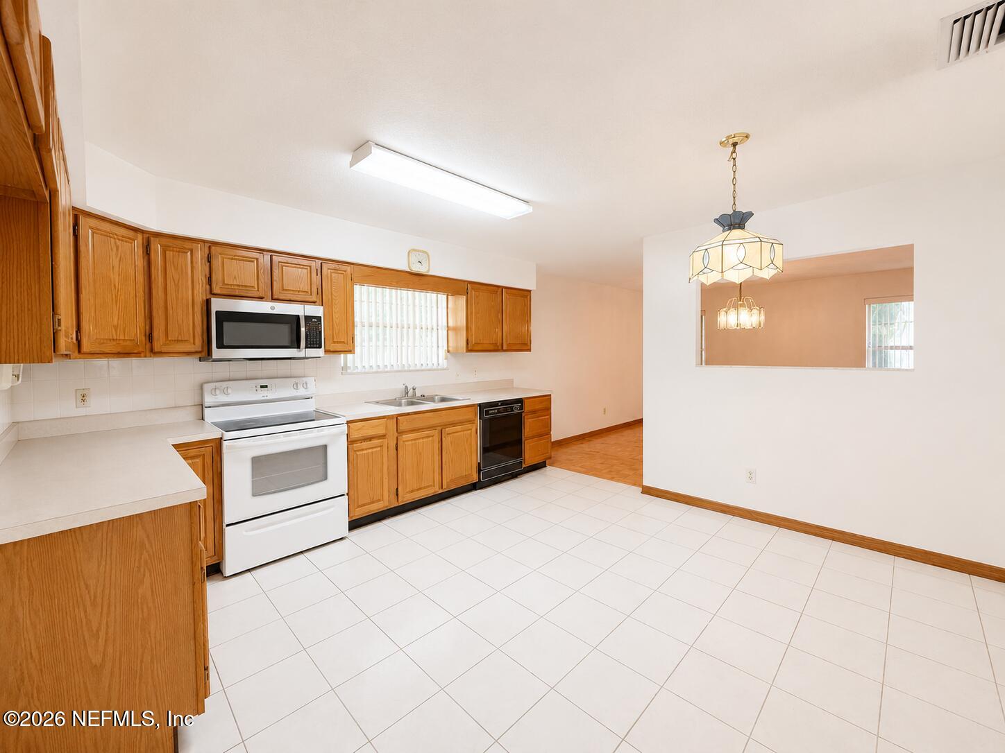 6 Surfcrest Street St. Augustine Beach, FL 32080 - Photo 5 of 15 a kitchen with stainless steel appliances granite countertop a stove a sink and a refrigerator