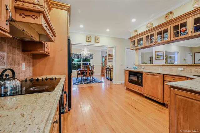 a kitchen with stainless steel appliances granite countertop a sink and wooden cabinets