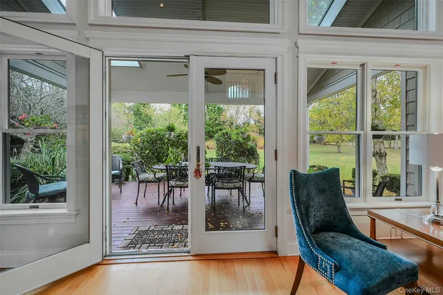 a view of a living room with a floor to ceiling window and wooden floor