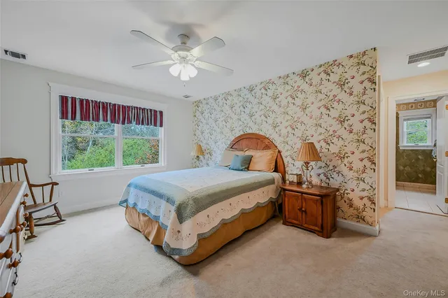 a spacious bedroom with a bed and a window