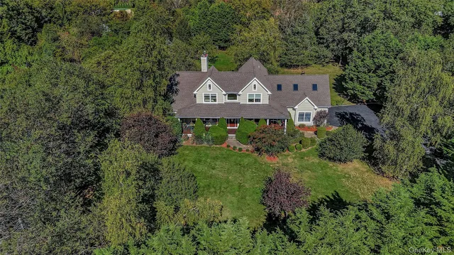 an aerial view of a house with a yard sitting space and garden