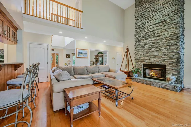 a living room with furniture a fireplace and a table