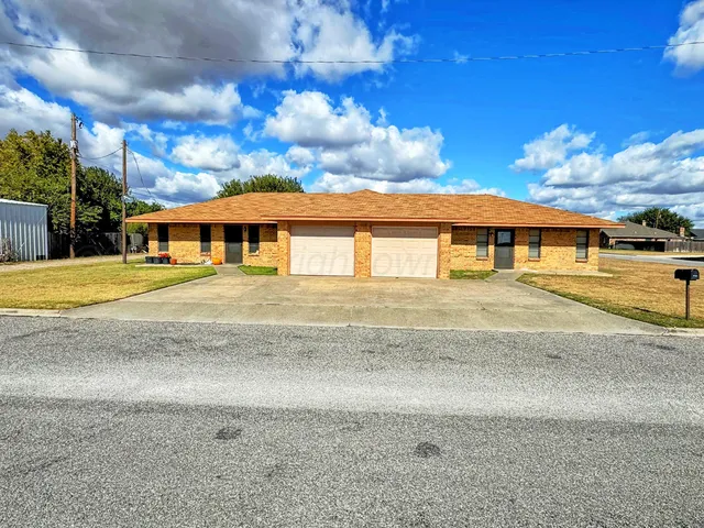 a view of a white house with a swimming pool