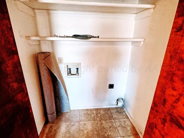 a view of walk in closet with clothes