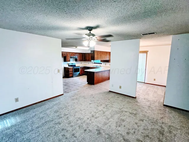 a kitchen with a refrigerator and a stove