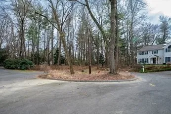 a view of a house with a yard covered with snow