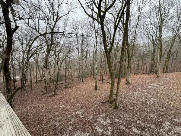 a view of a patio with a table chairs and wooden floor