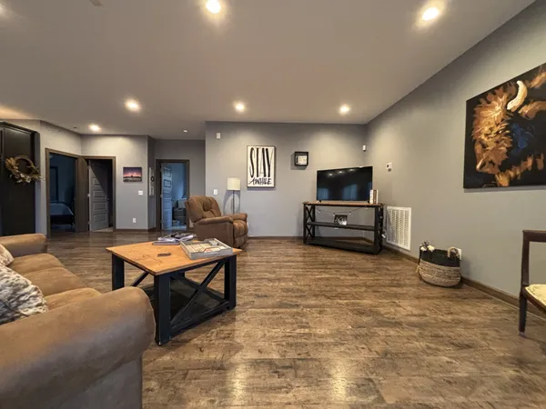 a living room with furniture and large windows
