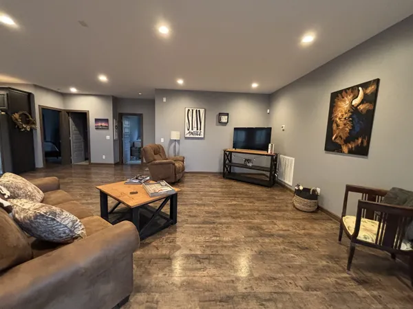 a kitchen with a dining table chairs and refrigerator