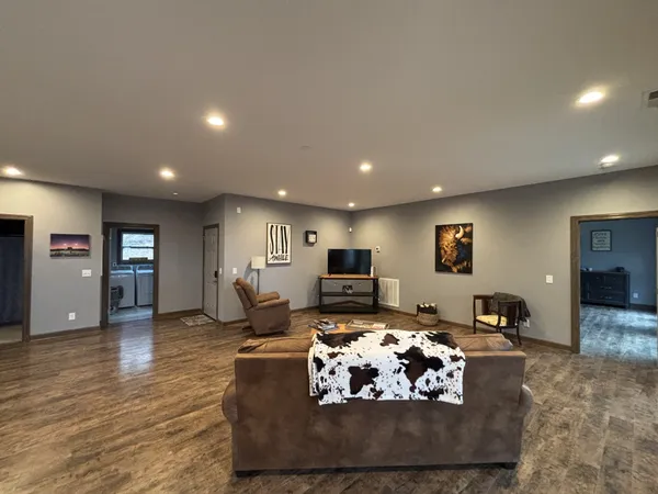 a large kitchen with kitchen island a large counter top space a sink stainless steel appliances and cabinets