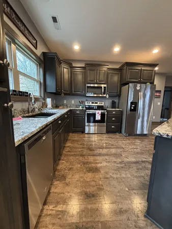 a bathroom with a granite countertop sink a mirror and a vanity