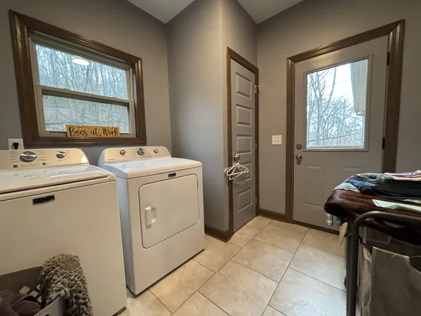 a room with a granite countertop sink and a mirror