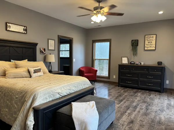 a bedroom with a bed and a chandelier