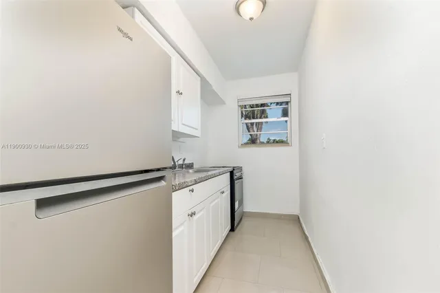 a sink with a granite countertop cabinets and a sink