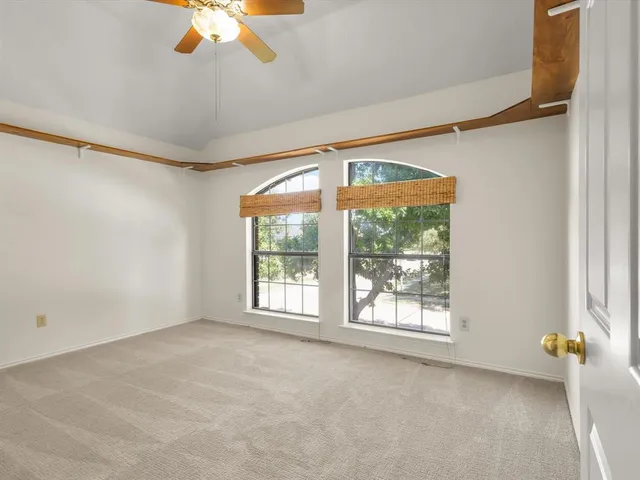 a view of a room with racks on the wall and a window