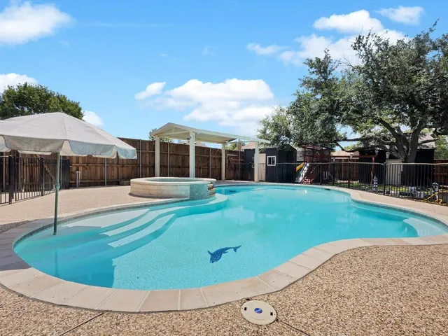 a view of a backyard with swimming pool