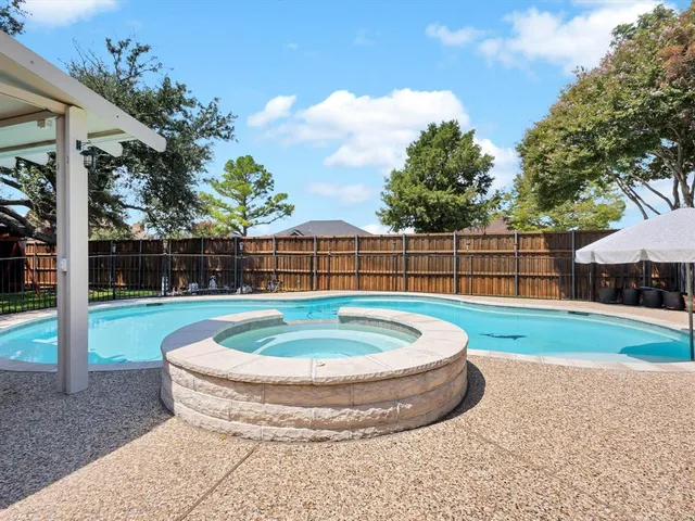 a view of a backyard with a small cabin and a large tree
