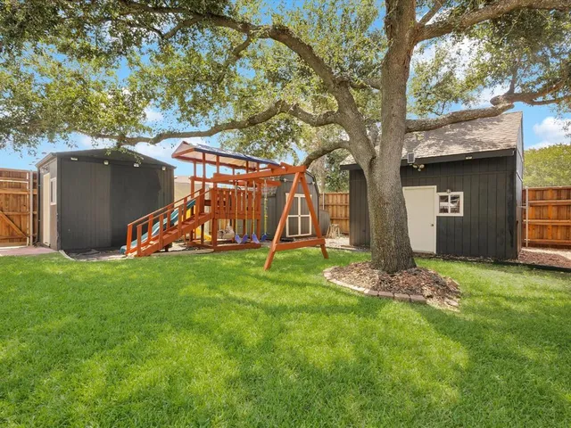an aerial view of a house with garden space and street view