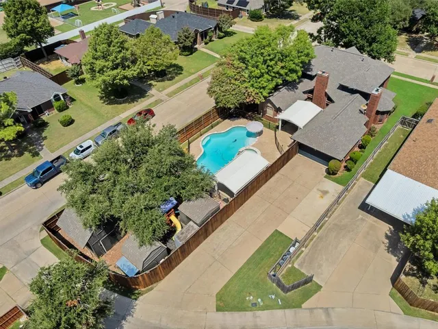 an aerial view of a residential houses with outdoor space