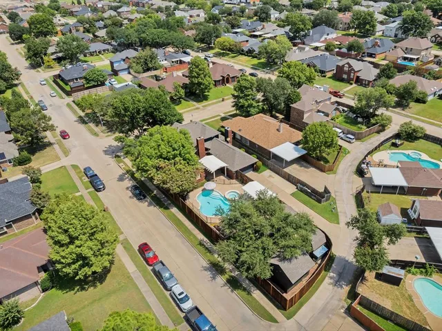 a front view of a house with a garden and plants