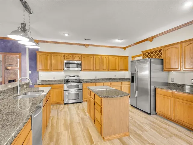 a kitchen that has a sink and a stove
