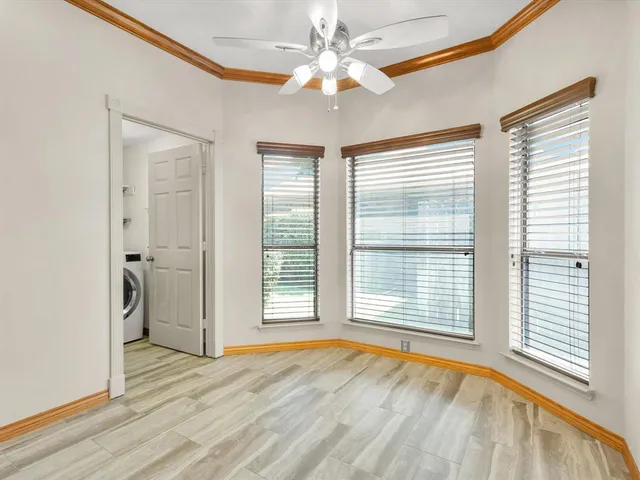 a view of an empty room with a fireplace and a window