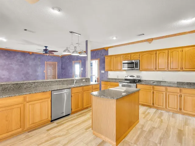 a spacious bathroom with a granite countertop sink and a large mirror