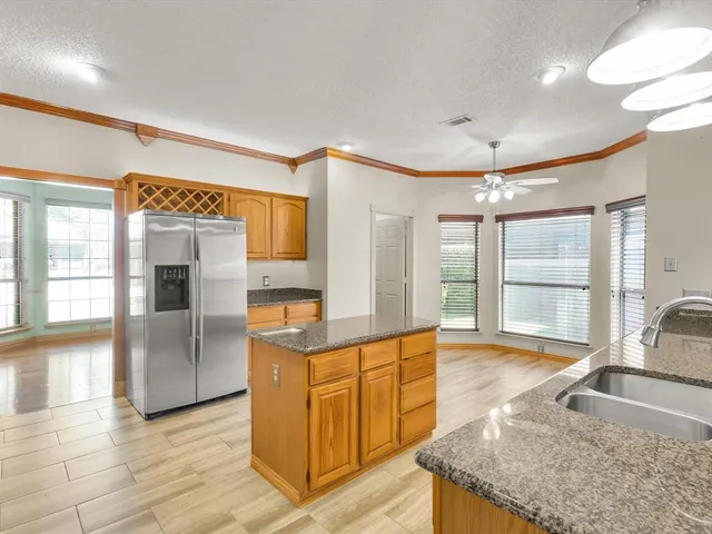 a bathroom with a granite countertop sink a mirror and a