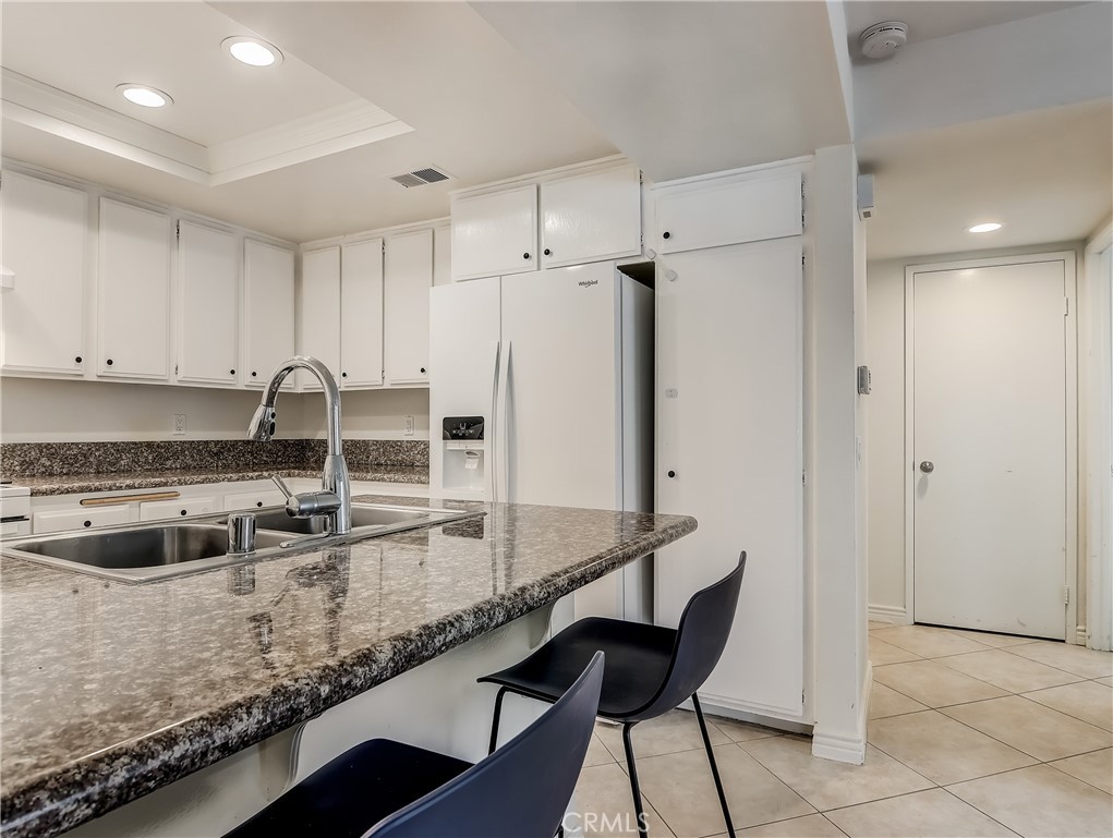 98 Greenfield, Unit 95 Irvine, CA 92614 - Photo 14 of 48 a kitchen with stainless steel appliances granite countertop a sink and a refrigerator