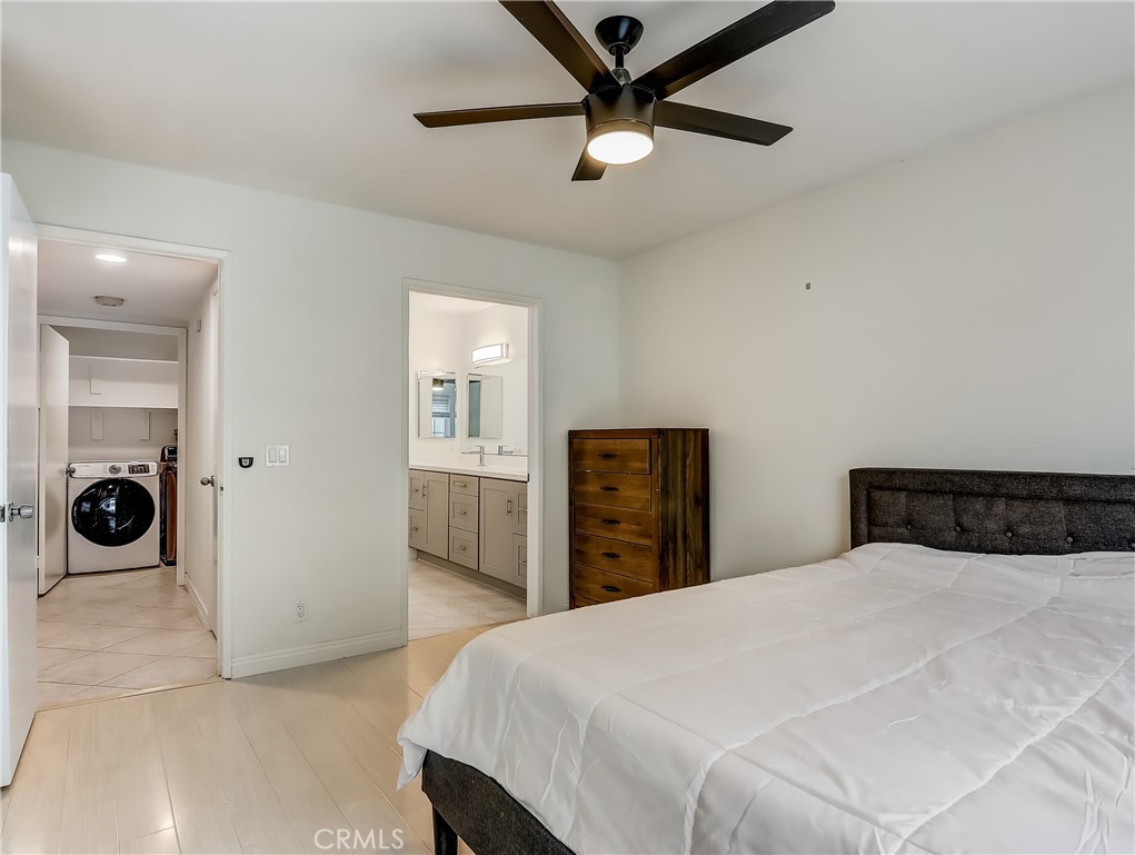 98 Greenfield, Unit 95 Irvine, CA 92614 - Photo 20 of 48 a bedroom with a bed and a chandelier