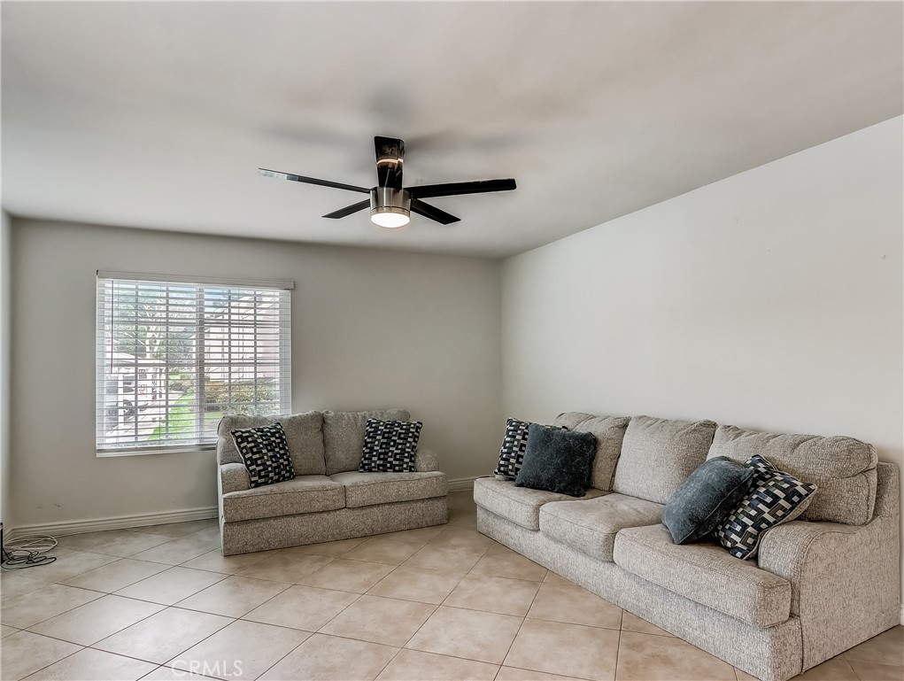 98 Greenfield, Unit 95 Irvine, CA 92614 - Photo 2 of 48 a living room with furniture and a ceiling fan