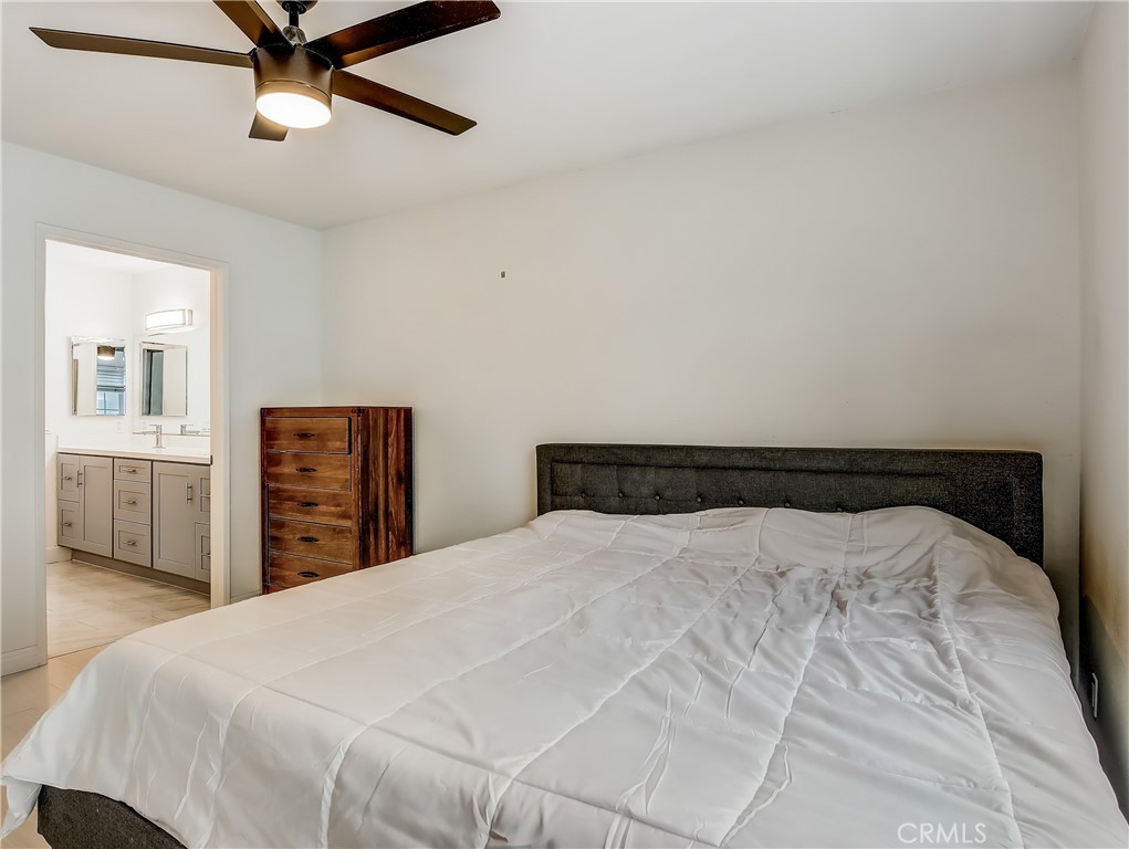 98 Greenfield, Unit 95 Irvine, CA 92614 - Photo 21 of 48 a bedroom with a bed and a dresser