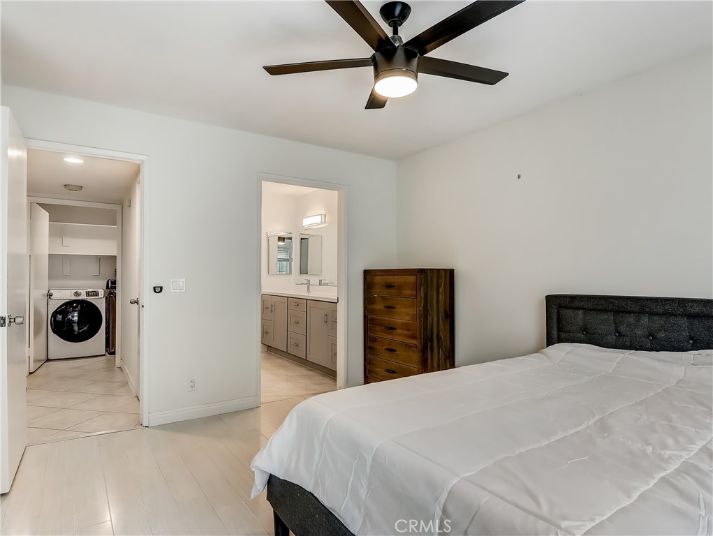 98 Greenfield, Unit 95 Irvine, CA 92614 - Photo 24 of 48 a bedroom with a bed and a chandelier