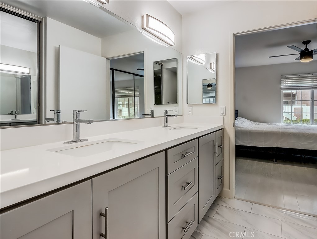 98 Greenfield, Unit 95 Irvine, CA 92614 - Photo 25 of 48 a bathroom with a sink double vanity and a mirror