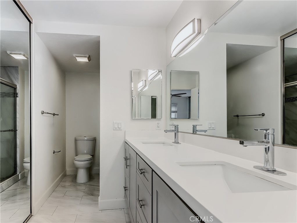 98 Greenfield, Unit 95 Irvine, CA 92614 - Photo 26 of 48 a bathroom with a sink and a large mirror