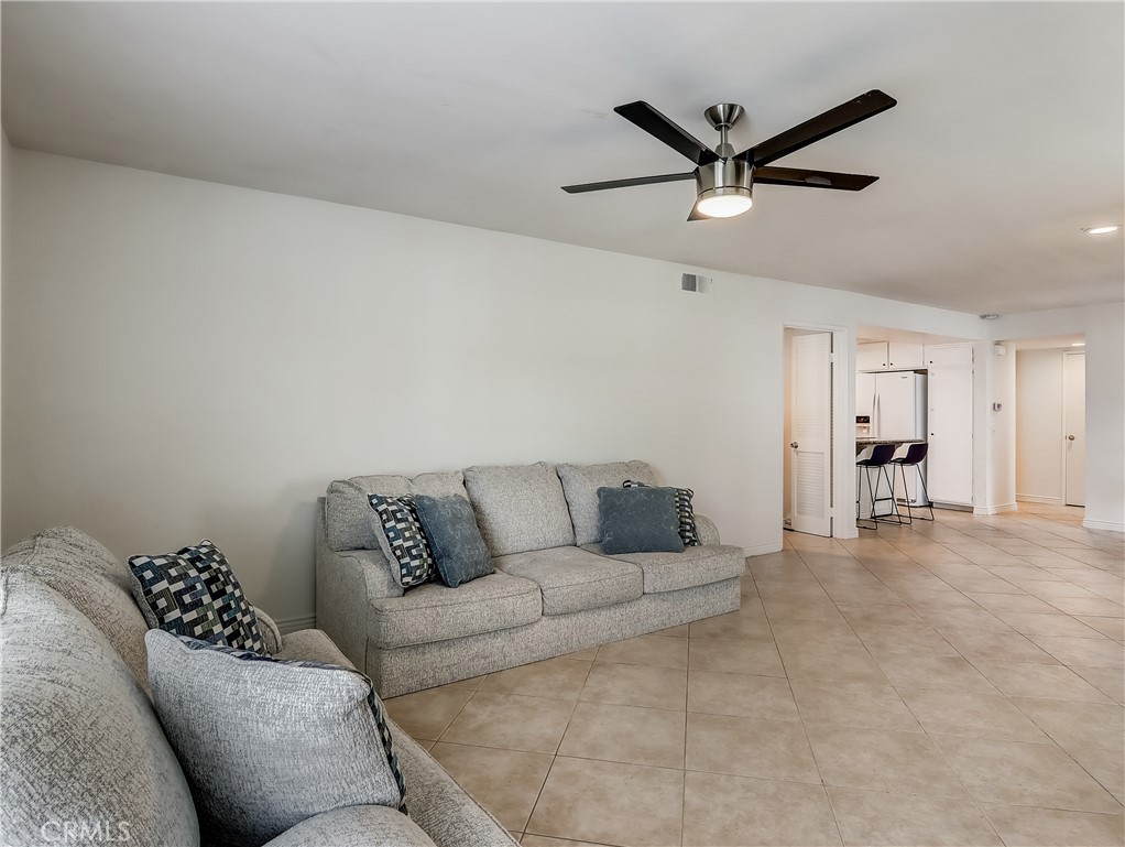 98 Greenfield, Unit 95 Irvine, CA 92614 - Photo 3 of 48 a living room with furniture and a ceiling fan